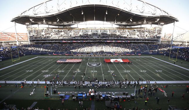 U.S. and Canadian flags are presented on the field before an NFL preseason football game between the Green Bay Packers and the Oakland Raiders on Thursday, Aug. 22, 2019, in Winnipeg, Manitoba. (John Woods/The Canadian Press via AP)