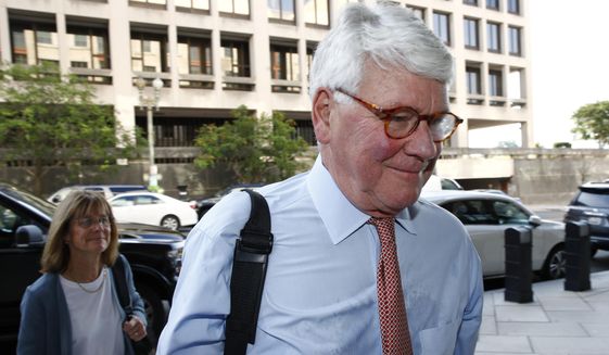 Greg Craig, former White House counsel to former President Barack Obama, walks into a federal courthouse for his trial, Thursday, Aug. 22, 2019, in Washington. (AP Photo/Patrick Semansky)