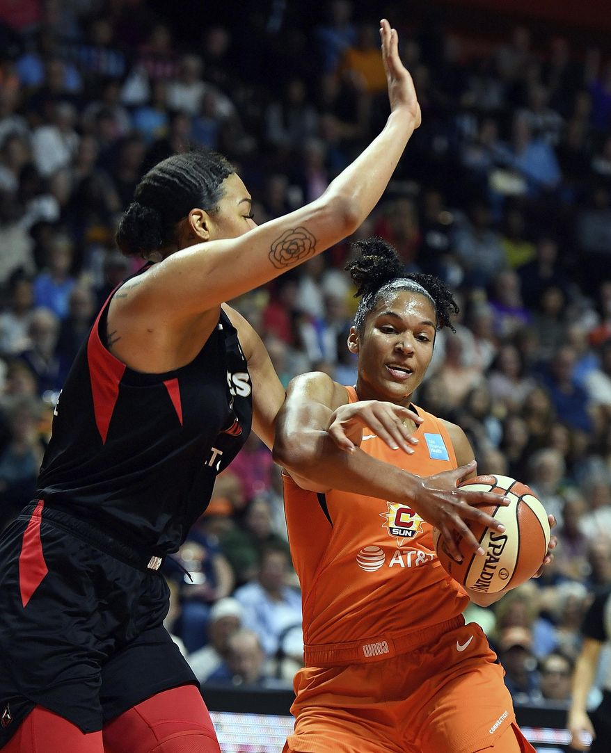 Connecticut Sun forward Alyssa Thomas, right, is fouled by Las Vegas Aces center Liz Cambage during a WNBA basketball game Friday, Aug. 23, 2019, in Uncasville, Conn. (Sean D. Elliot/The Day via AP)