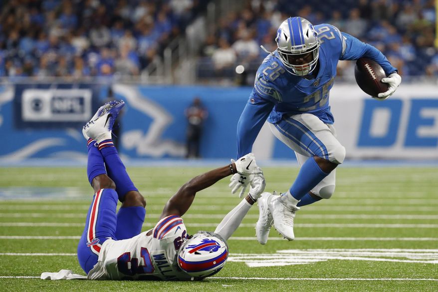 Detroit Lions running back C.J. Anderson (26) breaks the tackle of Buffalo Bills defensive back Levi Wallace (39) during the first half of an NFL preseason football game in Detroit, Friday, Aug. 23, 2019. (AP Photo/Rick Osentoski)