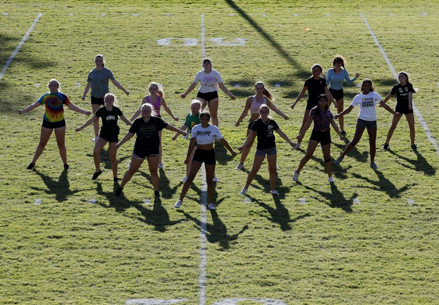 In this Thursday, Aug. 22, 2019, photo, Paradise High School cheerleaders practice in preparation for the football team's first game of the season in Paradise, Calif. Paradise's game against Williams High School on Friday will be the first game since a wildfire nearly destroyed the foothill community last year. (AP Photo/Rich Pedroncelli)
