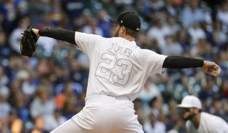 Milwaukee Brewers starting pitcher Jordan Lyles throws during the first inning of a baseball game against the Arizona Diamondbacks Friday, Aug. 23, 2019, in Milwaukee. (AP Photo/Morry Gash)