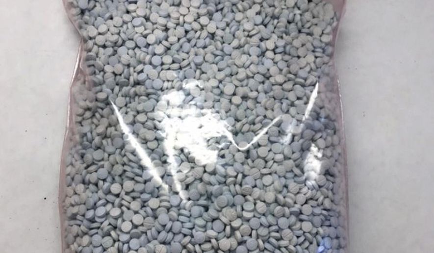 This undated photo released by the Arizona office of the Drug Enforcement Administration shows some of the 1.1 million fentanyl pills that have been seized in the state this fiscal year. DEA Special Agent in Charge Doug Coleman says most pills seized so far in the year ending Sept. 30, 2019 were made to mimic oxycodone M-30 tablets. Coleman says the pills known as "Mexican oxy" are largely manufactured south of the border and smuggled into the United States by drug cartels. He says the growing number being seen is "alarming." (Drug Enforcement Administration via AP)