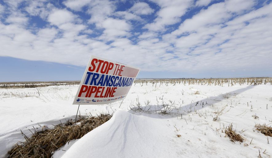In this March 11, 2013, file photo is a sign reading &quot;Stop the Transcanada Pipeline&quot; placed in a field near Bradshaw, Neb.  Nebraska&#x27;s highest court lifted one of the last major hurdles for the Keystone XL pipeline on Friday, Aug. 23, 2019 when it rejected another attempt to derail the project by opponents who wanted to force the developer to reapply for state approval. (AP Photo/Nati Harnik, File) **FILE**