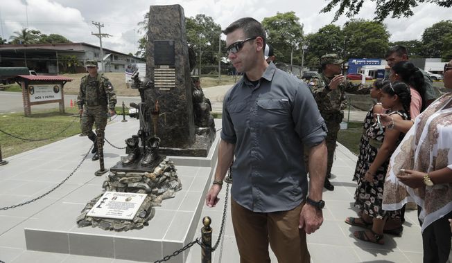 Acting U.S. Homeland Security Secretary Kevin McAleenan, center, walks during a ceremony for police officers fallen in action, at the Panama Border Police headquarter in Meteti, Panama, Friday, Aug. 23, 2019. (AP Photo/Arnulfo Franco)