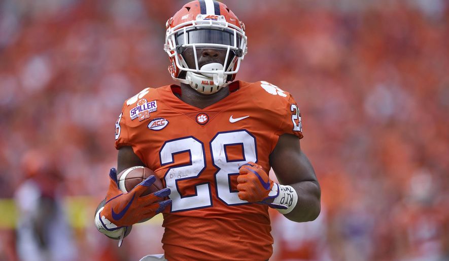 FILE - In this Sept. 29, 2018, file photo, then-Clemson's Tavien Feaster rushes up the field during the first half of an NCAA college football game against Syracuse in Clemson, S.C. South Carolina tailback Rico Dowdle leads a running game featuring three seniors and Clemson graduate transfer Tavien Feaster, who switched sides after three years and two national championship rings with the Tigers. (AP Photo/Richard Shiro, File)