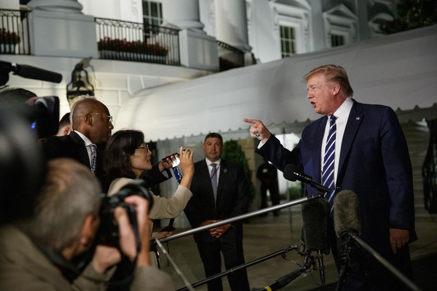 President Donald Trump speaks with reporters as he walks to Marine One on the South Lawn of the White House, Friday, Aug. 23, 2019, in Washington. Trump is en route to the G-7 summit in France. (AP Photo/Alex Brandon)