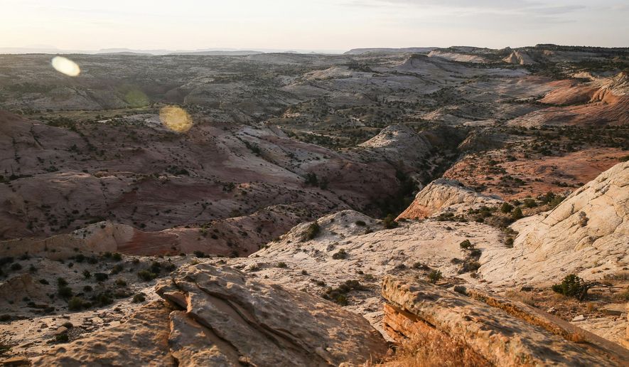 FILE - This July 9, 2017 file photo, shows a view of Grand Staircase-Escalante National Monument in Utah. The U.S. government&#x27;s final management plan for lands in and around the Utah national monument that President Donald Trump downsized is light on new protections for the cliffs, canyons, waterfalls and arches found there, but it does include a few more safeguards than were in a proposal last year. A summary the Bureau of Land Management provided to The Associated Press shows that the plan for the Grand Staircase-Escalante National Monument in southwestern Utah codifies that the lands cut out of the monument will be open to mineral extraction such as oil, gas and coal as expected. (Spenser Heaps/The Deseret News via AP, File)