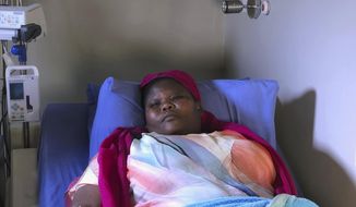 Comedian Samantha Kureya lays in her hospital bed in Harare, Thursday, Aug. 22, 2019. Kureya was abducted from her home, stripped naked and tortured by masked men with assault rifles, for performing skits perceived as being anti-government, the latest in a string of alleged abductions of government critics. (AP Photo/Tsvangirayi Mukwazhi)