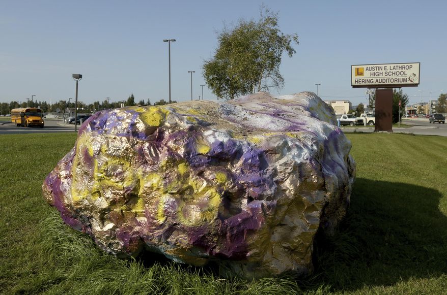In this Tuesday, Aug. 20, 2019, photo is Lathrop High School's Spirit Rock in Fairbanks, Alaska. It's the start of a new school year this week, an occasion marked for Fairbanks high schools with a fresh coat of paint on the school's "spirit rock." What's now a common pastime of students painting the boulders that sit outside of local high schools actually goes back several years, 30 years exactly this month, when the idea came from a teacher out of the high school. (Eric Engman/Fairbanks Daily News-Miner via AP)