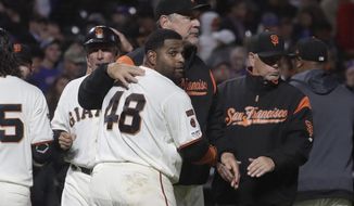 FILE - In this July 23, 2019, file photo, San Francisco Giants&#39; Pablo Sandoval (48) hugs manager Bruce Bochy after hitting a solo home run against the Chicago Cubs during the 13th inning of a baseball game in San Francisco. Sandoval will undergo season-ending Tommy John reconstructive surgery on his right elbow, and he became emotional at the thought of not playing again for retiring manager Bochy.  Sandoval will undergo surgery the first week of September in Los Angeles. (AP Photo/Jeff Chiu, File)