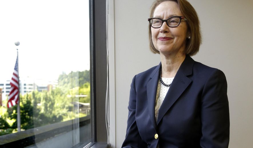 FILE - In this July 13, 2016 file photo, Oregon Attorney General Ellen Rosenblum poses for a photo at her office in Portland, Ore. Oregon's attorney general is telling the U.S. Supreme Court that Oregon's criminal justice system would be "overwhelmed" if the nation's highest court rules that nonunanimous jury verdicts are unconstitutional. If the U.S. Supreme Court finds nonunanimous juries unconstitutional, Rosenblum said in a brief filed Friday, Aug. 23, 2019, it could invalidate hundreds of convictions in Oregon. (AP Photo/Don Ryan, File)