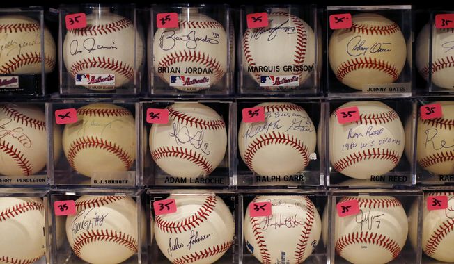 A portion of Bob and Susan Hope&#x27;s baseball collection is seen with price stickers attached, Friday, Aug. 23, 2019, in Stone Mountain, Ga. Susan died about two years ago, leaving behind the collection to her surviving husband. (AP Photo/Andrea Smith)