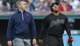 Cleveland Indians&#39; Jose Ramirez, right, walks off the field with a trainer during the first inning of the team&#39;s baseball game against the Kansas City Royals, Saturday, Aug. 24, 2019, in Cleveland. (AP Photo/Tony Dejak)