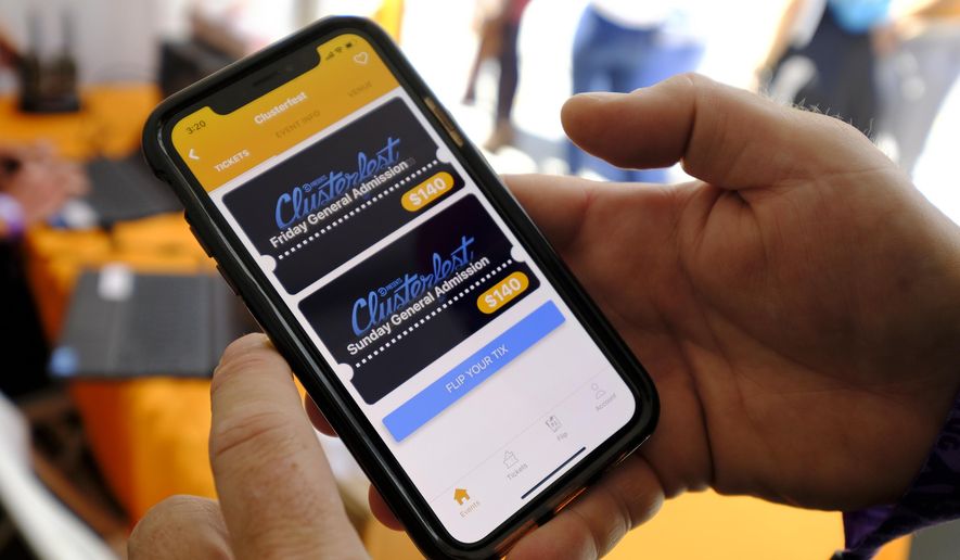 In this photo taken Friday, June 21, 2019, FlipTix CEO Jaime Siegel demonstrates his company's application at the Clusterfest comedy event in San Francisco. The company's application lets people who leave a venue early sell their ticket and lets someone who wants the remainder of the ticket buy it. (AP Photo/Eric Risberg)