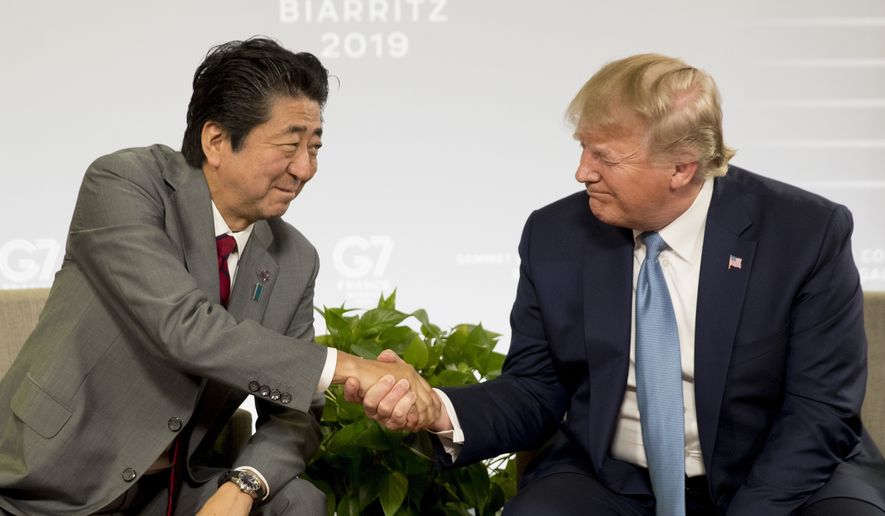 U.S President Donald Trump and Japanese Prime Minister Shinzo Abe shake hands as they participate in a bilateral meeting at the G-7 summit in Biarritz, France, Sunday, Aug. 25, 2019. (AP Photo/Andrew Harnik)