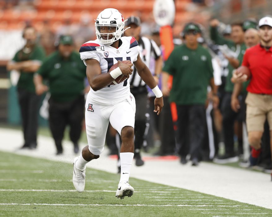 Arizona quarterback Khalil Tate (14) runs down the sideline during the second quarter during of the team's NCAA college football game against Hawaii on Saturday, Aug. 24, 2019, in Honolulu. (AP Photo/Marco Garcia)