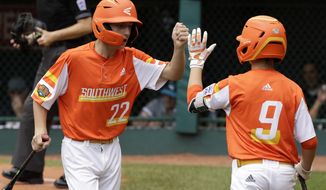 River Ridge, Louisiana&#39;s Reece Roussel (22) celebrates with Conner Perrot after scoring on a double by Marshall Louque off Curacao pitcher Keven Rosina during the third inning if the Little League World Series Championship game in South Williamsport, Pa., Sunday, Aug. 25, 2019. (AP Photo/Gene J. Puskar)