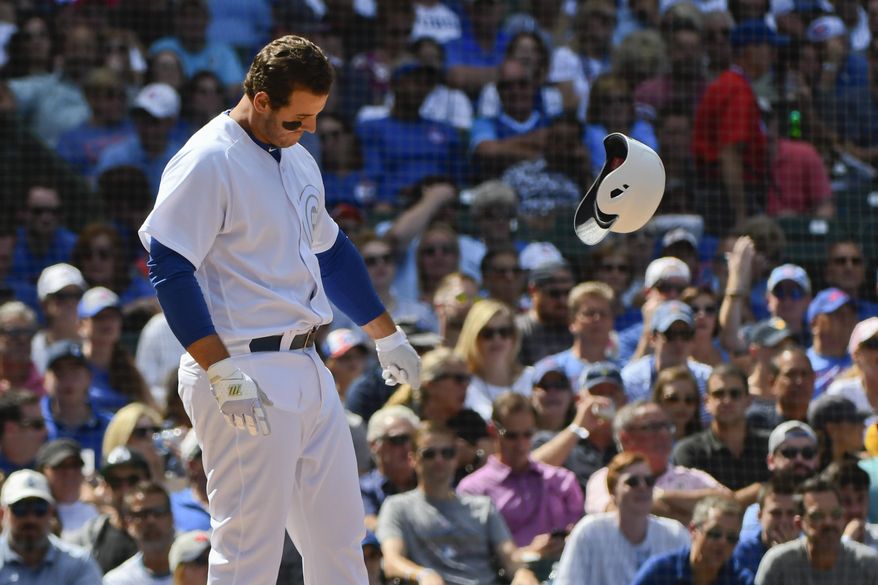 Chicago Cubs' Anthony Rizzo throws his helmet after striking out swinging during the fourth inning of a baseball game against the Washington Nationals, Friday, Aug. 23, 2019, in Chicago. (AP Photo/Matt Marton)