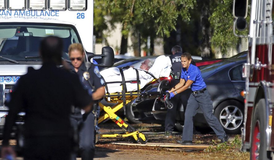 FILE - In this Wednesday, Sept. 13, 2017 file photo, a woman is transported from The Rehabilitation Center at Hollywood Hills as patients are evacuated after a loss of air conditioning due to Hurricane Irma in Hollywood, Fla. Defense attorneys said Sunday, August 25, 2019 that arrests are expected shortly in the case of a Florida nursing home where 12 elderly patients died after the complex lost power and was engulfed by sweltering heat during a powerful 2017 hurricane. (Amy Beth Bennett/South Florida Sun-Sentinel via AP, File)