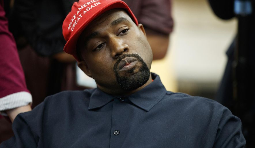 FILE - In this Oct. 11, 2018, file photo rapper Kanye West listens to a question from a reporter during a meeting in the Oval Office of the White House with President Donald Trump in Washington. On Sunday, Aug. 25, 2019, Kanye West hosted a Sunday Service in Ohio in support of those affected by the recent mass shooting. A large crowd gathered at the service in a park in Dayton. (AP Photo/Evan Vucci, File)