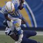 Los Angeles Chargers running back Austin Ekeler is tackled by Seattle Seahawks outside linebacker K.J. Wright during the first half of an NFL preseason football game Saturday, Aug. 24, 2019, in Carson, Calif. (AP Photo/Gregory Bull)