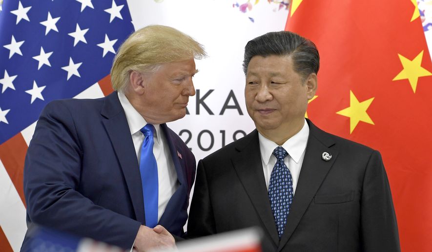In this June 29, 2019, file photo, U.S. President Donald Trump, left, shakes hands with Chinese President Xi Jinping during a meeting of the G-20 summit in Osaka, western Japan. (AP Photo/Susan Walsh, File)