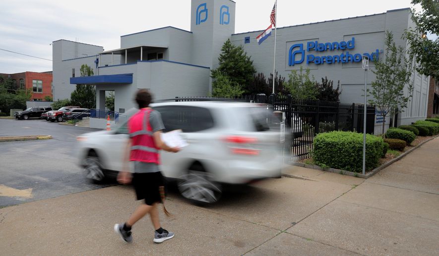 FILE - In this June 21, 2019, file photo, a motorist enters Planned Parenthood of the St. Louis Region and Southwest Missouri. Critics of new abortion restrictions in Missouri are headed to court to try to block the law from taking effect. Attorneys for Planned Parenthood will argue Monday, Aug. 26, 2019, that the law should be temporarily blocked until the lawsuit is decided. (Christian Gooden/St. Louis Post-Dispatch via AP, File)