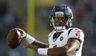 FILE - In this Thursday Aug. 8, 2019, file photo, Houston Texans quarterback Deshaun Watson warms up before the start of an NFL preseason football game against the Green Bay Packers in Green Bay, Wis. The Texans are without a general manager while coach Bill O’Brien works to improve an 11-6 record and find a way to win in the postseason after Indianapolis beat Houston on its own field. (AP Photo/Jeffrey Phelps, File)