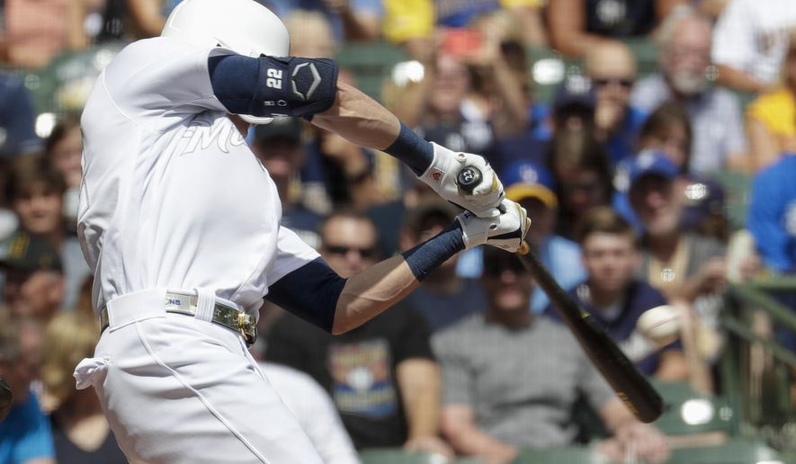 Milwaukee Brewers' Christian Yelich hits a single during the first inning of a baseball game against the Arizona Diamondbacks Sunday, Aug. 25, 2019, in Milwaukee. (AP Photo/Morry Gash)