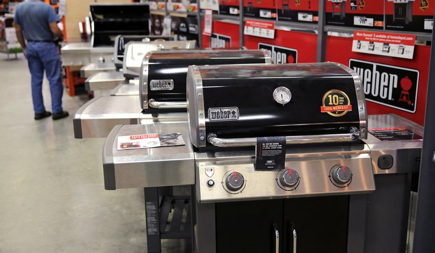 FILE - In this July 11, 2019, file photo Weber grills are displayed at the Home Depot store in Londonderry, N.H. The Home Depot Inc. on Tuesday, Aug. 20, reported fiscal second-quarter net income of $3.48 billion. (AP Photo/Charles Krupa, File)