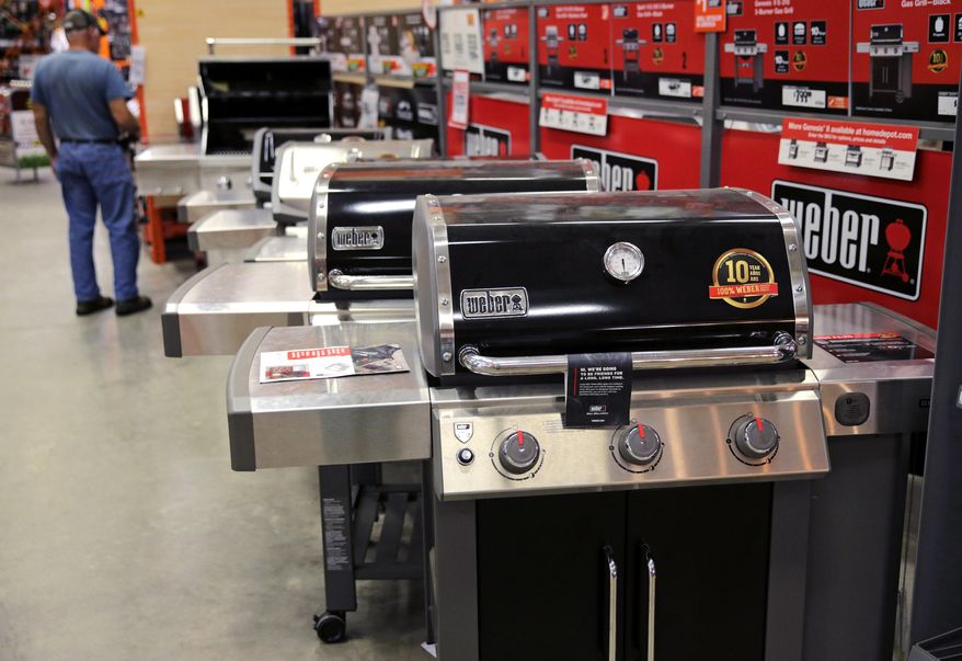 FILE - In this July 11, 2019, file photo Weber grills are displayed at the Home Depot store in Londonderry, N.H. The Home Depot Inc. on Tuesday, Aug. 20, reported fiscal second-quarter net income of $3.48 billion. (AP Photo/Charles Krupa, File)