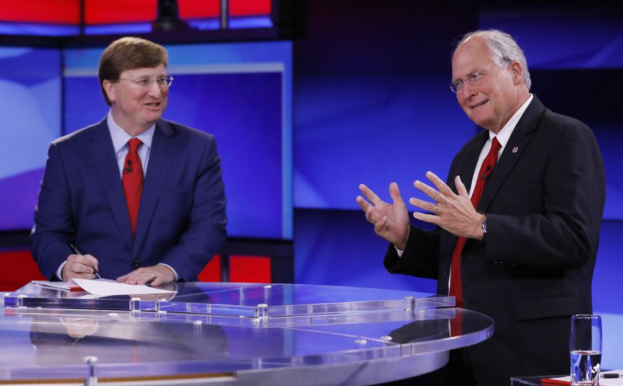 Lt. Gov. Tate Reeves, left, laughs as his GOP gubernatorial runoff opponent former Mississippi Supreme Court Chief Justice Bill Waller Jr., makes a comment prior to their televised debate in Jackson, Miss., Wednesday, Aug. 21, 2019. (AP Photo/Rogelio V. Solis)