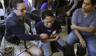 Gary Sanchez, of Honduras, right, watches as his wife, Mariela comforts their son, Jonathan, 16, during a news conference, Monday, Aug. 26, 2019, in Boston. The Sanchez family came to the United States seeking treatment for Jonathan&#39;s cystic fibrosis. Doctors and immigrant advocates say federal immigration authorities are unfairly ordering foreign-born children granted deferred action for medical treatment to return to their countries. (AP Photo/Elise Amendola) **FILE**