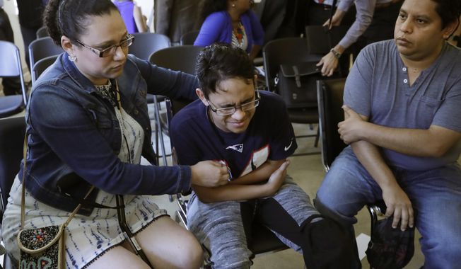 Gary Sanchez, of Honduras, right, watches as his wife, Mariela comforts their son, Jonathan, 16, during a news conference, Monday, Aug. 26, 2019, in Boston. The Sanchez family came to the United States seeking treatment for Jonathan&#x27;s cystic fibrosis. Doctors and immigrant advocates say federal immigration authorities are unfairly ordering foreign-born children granted deferred action for medical treatment to return to their countries. (AP Photo/Elise Amendola) **FILE**