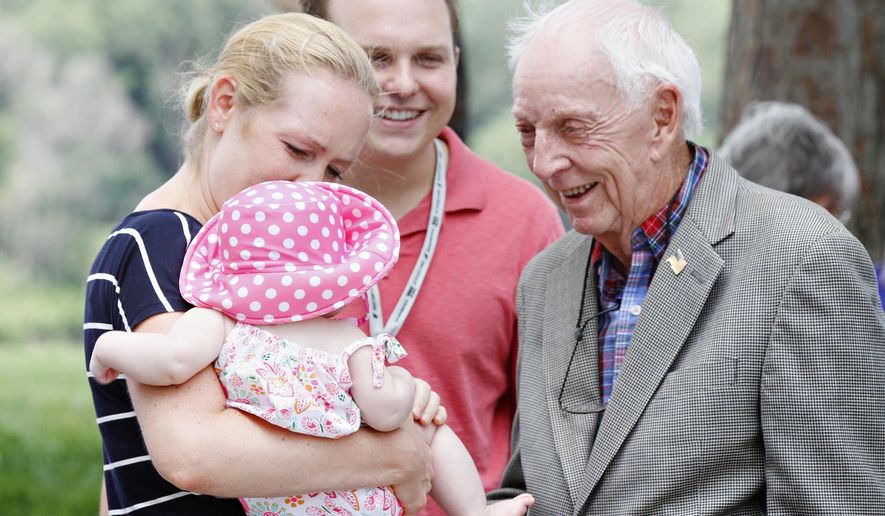 FILE - In this July 20, 2014, file photo, United Airlines flight 232 Capt. Al Haynes, right, smiles as he visits with survivors and family members following a remembrance service held in conjunction with the 25th Anniversary of the United Airlines flight 232 crash in Sioux City, Iowa. Haynes, a pilot credited for saving the lives of nearly 200 people by guiding the damaged passenger jet into a crash landing at an Iowa airport in 1989, has died. Haynes died Sunday, Aug. 25, 2019 at age 87 in a Seattle-area hospital, said Gary Brown, an emergency services director for Woodbury County, Iowa. (AP Photo/The Sioux City Journal, Dawn J. Sagert, File)