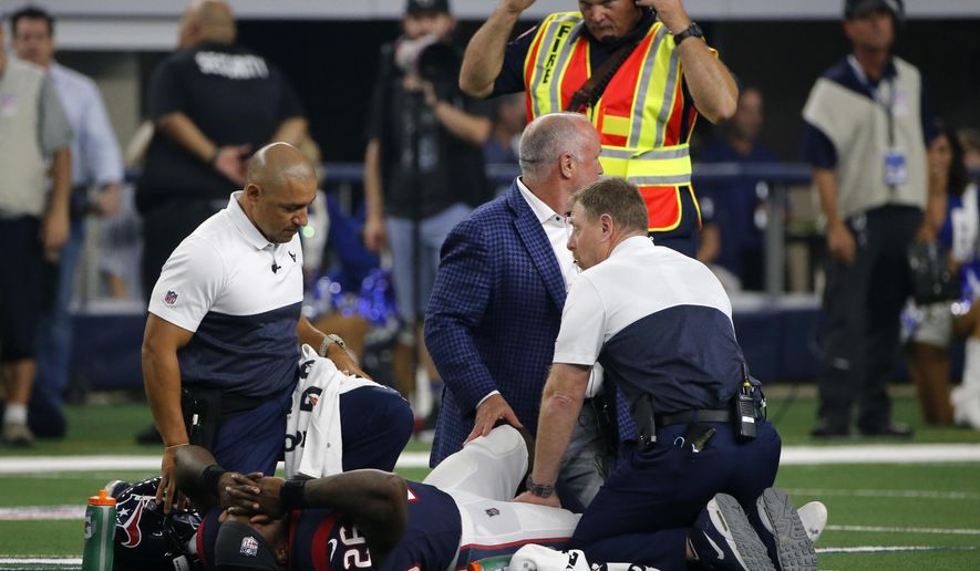Houston Texans staff check on running back Lamar Miller (26) after he suffered an unknown injury in the first half of a preseason NFL football game against the Dallas Cowboys in Arlington, Texas, Saturday, Aug. 24, 2019. (AP Photo/Michael Ainsworth)