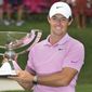 Rory McIlroy, of Northern Ireland, holds up the FedEx Cup trophy after winning the Tour Championship golf tournament Sunday, Aug. 25, 2019, in Atlanta. (AP Photo/John Amis)