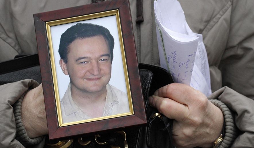 FILE - In this Nov. 30, 2009, file photo a portrait of lawyer Sergei Magnitsky, who died in jail, is held by his mother Nataliya Magnitskaya, as she speaks during an interview with the AP in Moscow. A top European court says Russia&#39;s failure to provide adequate medical care to jailed lawyer Sergei Magnitsky could have led to his 2009 death, which led to U.S. and European sanctions. The France-based European Court of Human Rights on Tuesday ordered Russia to pay Magnitsky&#39;s wife and mother 34,000 euros in damages. (AP Photo/Alexander Zemlianichenko, File)