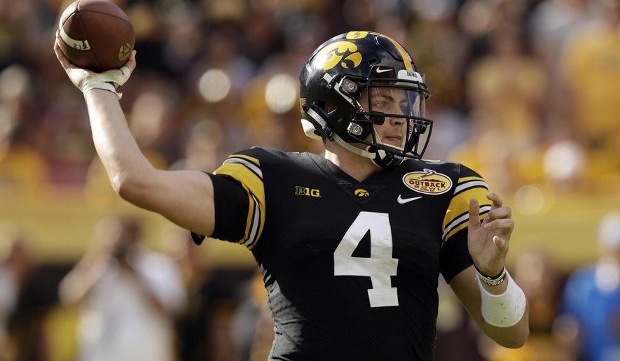 FILE - In this Jan. 1, 2019, file photo, Iowa quarterback Nate Stanley throws a pass against Mississippi State during the second half of the Outback Bowl NCAA college football game Tuesday,, in Tampa, Fla. Stanley threw for 52 touchdowns in his first two seasons as a starter, the most in school history, and he’s just 23 more scores away from passing Heisman Trophy runner-up Chuck Long for the No. 1 spot. And while Stanley has over 5,000 fewer yards passing than Long did, he’s within striking distance of Drew Tate for second on that list. (AP Photo/Chris O'Meara, File)