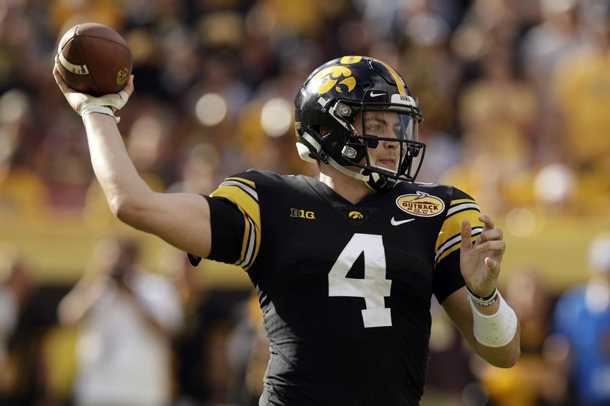 FILE - In this Jan. 1, 2019, file photo, Iowa quarterback Nate Stanley throws a pass against Mississippi State during the second half of the Outback Bowl NCAA college football game Tuesday,, in Tampa, Fla. Stanley threw for 52 touchdowns in his first two seasons as a starter, the most in school history, and he’s just 23 more scores away from passing Heisman Trophy runner-up Chuck Long for the No. 1 spot. And while Stanley has over 5,000 fewer yards passing than Long did, he’s within striking distance of Drew Tate for second on that list. (AP Photo/Chris O'Meara, File)