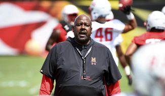 In this Aug. 2, 2019, file photo, Maryland head coach Mike Locksley speaks to his team as they work out during NCAA college football training camp in College Park, Md. With a new quarterback in Josh Jackson and a revamped playbook with an Alabama flair, Maryland&#39;s offense under first-year coach Locksley has the potential to ring up plenty of points. (AP Photo/Will Newton, File) **FILE**