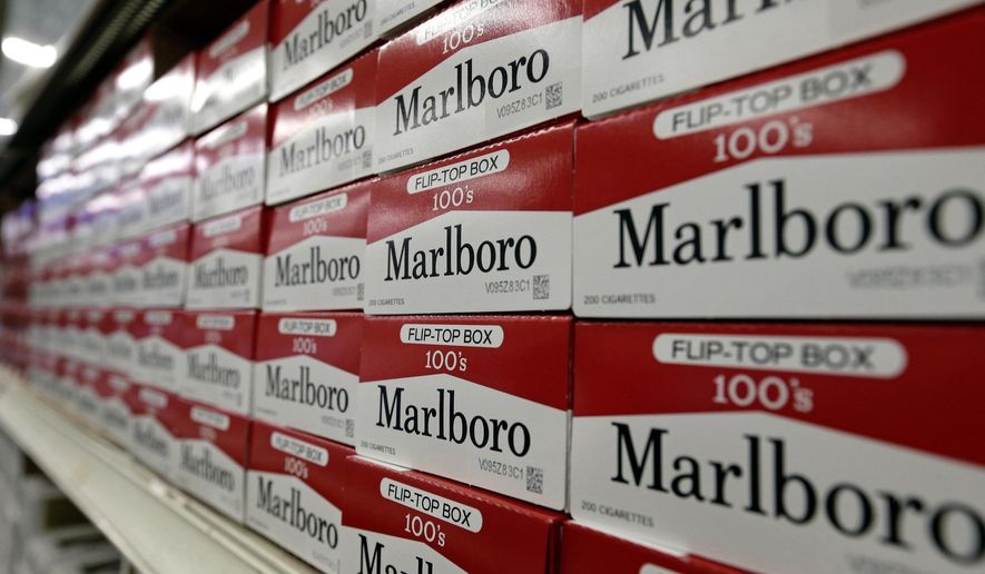 This June 14, 2018, file photo shows cartons of Marlboro cigarettes on the shelves at JR outlet in Burlington, N.C. On Oct. 3, 2019, Midwestern grocery chain Schnucks announced it will end tobacco sales in its stores as of Jan. 1, 2020. (AP Photo/Gerry Broome, File) **FILE**