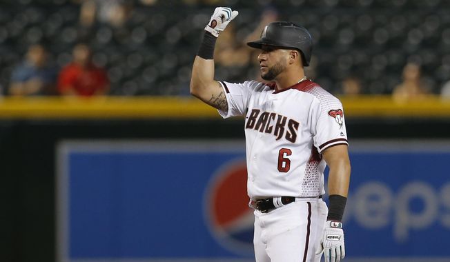 Arizona Diamondbacks&#x27; David Peralta reacts after hitting a double against the Colorado Rockies in the seventh inning during a baseball game, Monday, Aug. 19, 2019, in Phoenix. (AP Photo/Rick Scuteri)