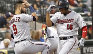 Minnesota Twins&#39; Jonathan Schoop (16) celebrates his home run off Chicago White Sox starting pitcher Lucas Giolito with Marwin Gonzalez during the second inning of a baseball game Tuesday, Aug. 27, 2019, in Chicago. (AP Photo/Charles Rex Arbogast)