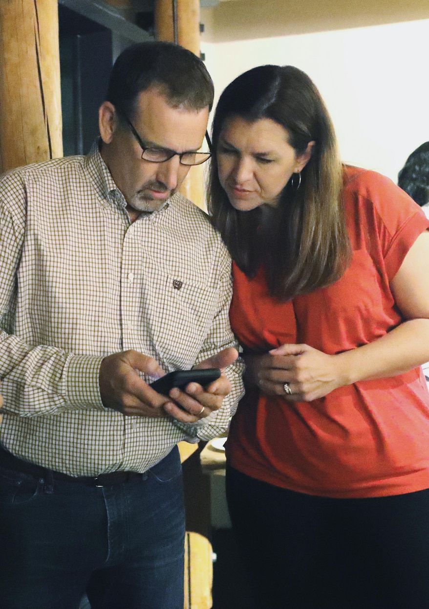 Republican Megan Dahle, right, checks early election results with husband, state Sen. Brian Dahle at her election watch party in Redding, Calif., Tuesday night, Aug. 27, 2019. Dahle, of Bieber, is seeking to win the Assembly District 1 seat that was vacated when her husband was elected to the California Senate. (Mike Chapman/The Record Searchlight via AP)