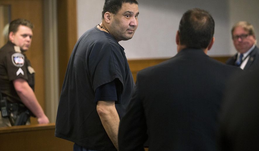 Julio Carrillo looks back at his attorney, Derrick X. Banda, as the court goes into recess during his sentencing hearing Wednesday, Aug. 28, 2019, in Belfast, Maine. Carrillo was sentenced to 55 years in prison for the beating death of his 10-year-old stepdaughter, a crime that led to changes in the state welfare system. (Brianna Soukup/Portland Press Herald via AP)