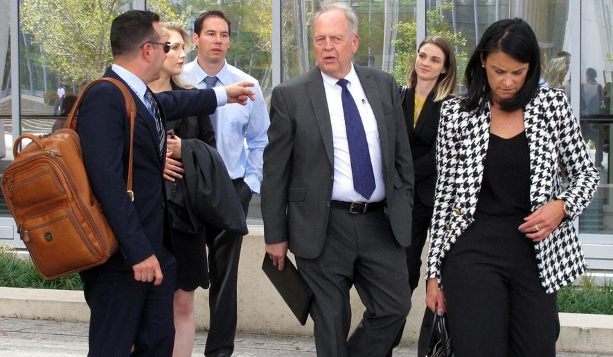 Fired doctor William Husel, third from left, leaves court with his new attorneys, Jose Baez, far left, and Diane Menashe, far right, and others following a hearing Wednesday, Aug. 28, 2019, in Columbus, Ohio. Husel is accused of ordering excessive painkiller doses for hospital patients and has pleaded not guilty to 25 counts of murder. (AP Photo/Kantele Franko)