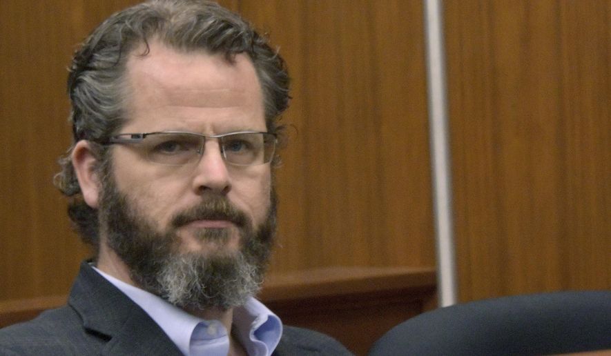 FILE - In this May 25, 2016, file photo former state Rep. Todd Courser attends a probable cause hearing before Judge Hugh Clarke in 65th District Court in Lansing, Mich. Courser has pleaded no contest to a misdemeanor stemming from charges filed over his role in trying to keep his extramarital affair with another legislator from being exposed. The state attorney general's office says Courser entered his plea in a Lapeer County, Mich., courtroom Wednesday, and could serve up to a year in jail on a willful neglect of duty charge. (Dale G. Young /Detroit News via AP, File)