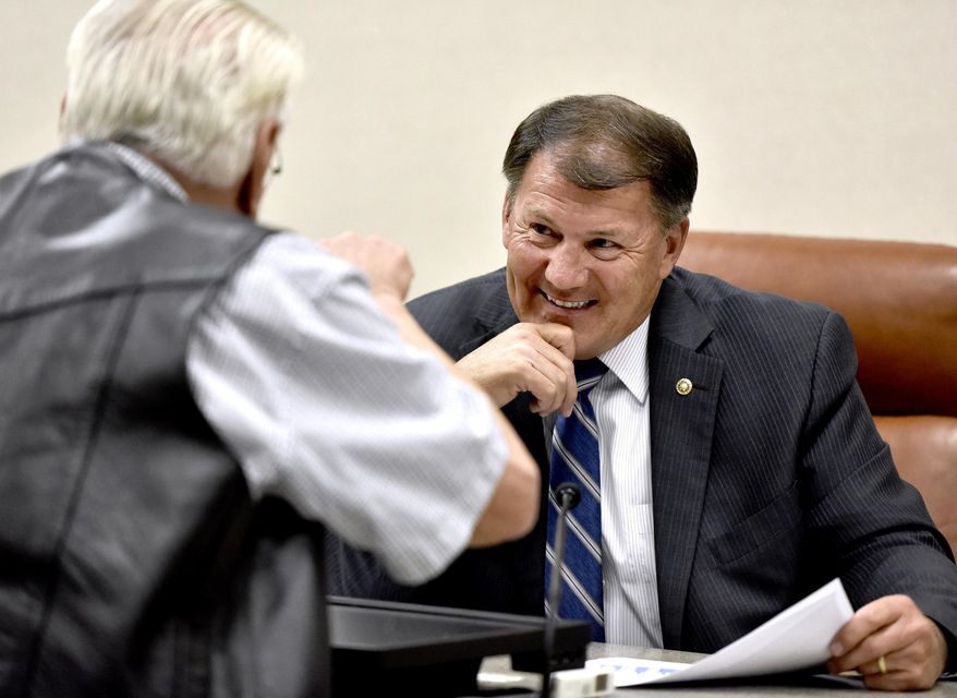 U.S. Sen. Mike Rounds, R-SD, chairman of the Senate subcommittee on Superfund, Waste Management and Regulatory Oversight, listens as Bill Beacom of Sioux City, Iowa, a retired Missouri River ship captain, makes a point after Rounds held a hearing on the U.S. Army Corps of Engineers' management of 2019 Missouri River Basin flooding Wednesday, Aug. 28, 2019, in North Sioux City, South Dakota. (Tim Hynds/Sioux City Journal via AP)